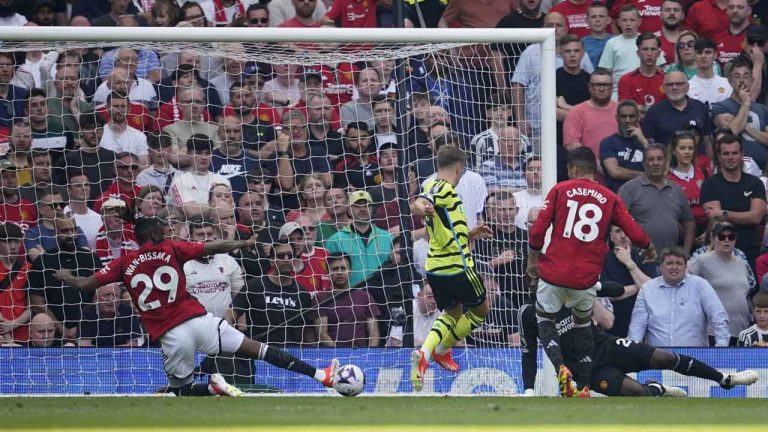Arsenal's Leandro Trossard, centre, scores his side's opening goal during the English Premier League soccer match between Manchester United and Arsenal at the Old Trafford Stadium in Manchester. (Dave Thompson/AP)