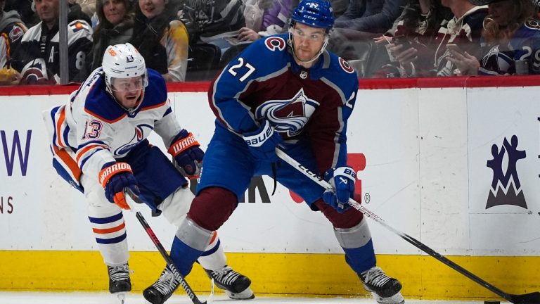 Colorado Avalanche left wing Jonathan Drouin, right, looks to pass the puck as Edmonton Oilers center Mattias Janmark defends during the second period of an NHL hockey game Thursday, April 18, 2024, in Denver. (David Zalubowski/AP)