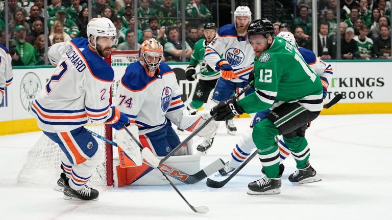 Edmonton Oilers' Evan Bouchard (2) and Stuart Skinner (74) and Dallas Stars center Radek Faksa (12) watch the puck during the first period of Game 1 of the Western Conference finals in the NHL hockey Stanley Cup playoffs Thursday, May 23, 2024, in Dallas. (Tony Gutierrez/AP)
