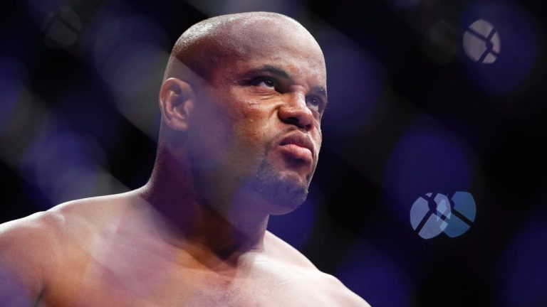 Daniel Cormier stands in the octagon before a heavyweight title mixed martial arts bout against Stipe Miocic at UFC 226 in 2018, (John Locher/AP)