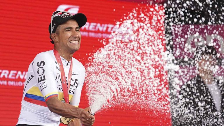 Jhonatan Narváez celebrates with sparkling wine on podium after winning the stage 1 of the Giro d'Italia from Venaria Reale to Turin, Italy. (Massimo Paolone/AP)