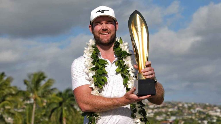 Grayson Murray holds the trophy after winning the Sony Open golf event. (Matt York/AP)
