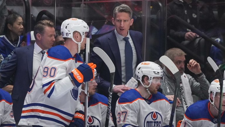 Edmonton Oilers head coach Kris Knoblauch, back centre, talks to Corey Perry (90) during the first period in Game 1 of an NHL hockey Stanley Cup second-round playoff series against the Vancouver Canucks, in Vancouver, on Wednesday, May 8, 2024. (Darryl Dyck/THE CANADIAN PRESS)