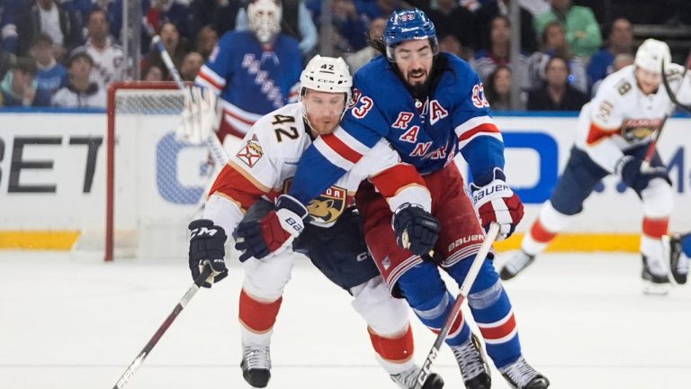 Florida Panthers' Gustav Forsling (42) fights for control of the puck against New York Rangers' Mika Zibanejad (93) during the second period of Game 5 in the Eastern Conference finals of the NHL hockey Stanley Cup playoffs Thursday, May 30, 2024, in New York, N.Y. (Frank Franklin II/AP)