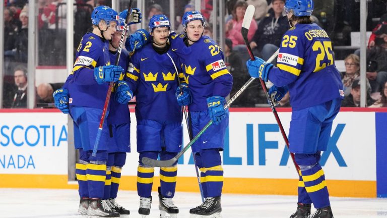 Sweden's Simon Robertsson, centre, celebrates his goal with teammates Elias Pettersson, left to right, Ludvig Jansson, Oskar Pettersson, and Milton Oscarsson during second period IIHF World Junior Hockey Championship hockey action against Austria in Halifax on Monday, December 26, 2022. (Darren Calabrese/CP)