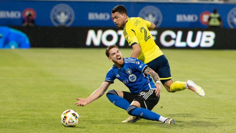 CF Montreal's Joel Waterman, front, goes down after battling with Nashville SC's Daniel Lovitz during first half MLS soccer action in Montreal on Saturday, May 25, 2024. (Peter McCabe/CP Photo)