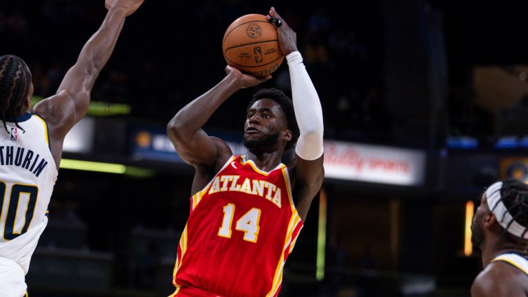 Atlanta Hawks forward AJ Griffin shoots between Indiana Pacers guards, Bennedict Mathurin and Buddy Hield during an NBA preseason game, Oct. 16, 2023. (AP Photo/Michael Conroy)