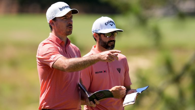Canadian golfers Nick Taylor and Adam Hadwin talk on the ninth hole during a practice round for the U.S. Open golf tournament Tuesday, June 11, 2024, in Pinehurst, N.C. (George Walker IV/AP)