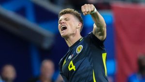Scotland's Scott McTominay celebrates after Switzerland's Fabian Schar scored an own goal during a Group A match between Scotland and Switzerland at the Euro 2024 soccer tournament in Cologne, Germany, Wednesday, June 19, 2024. (Rolf Vennenbernd/dpa via AP)