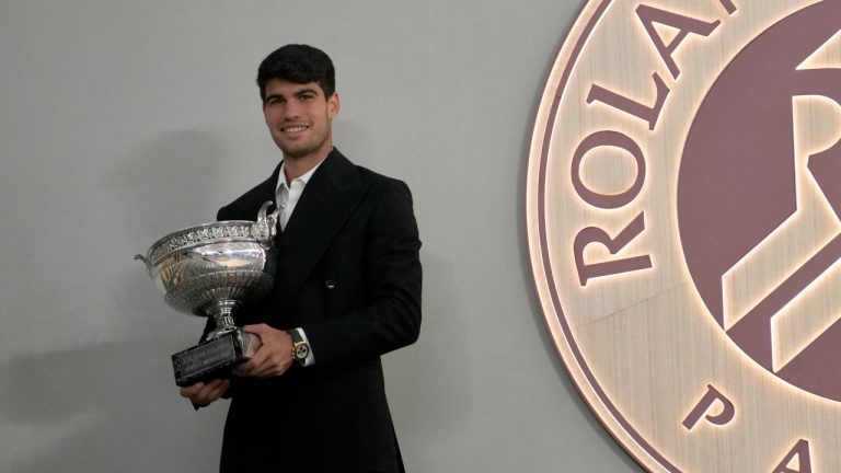 Spain's Carlos Alcaraz holds the trophy after the French Open tournament at the Roland Garros stadium. Monday, June 10, 2024. (AP Photo/Christophe Ena)