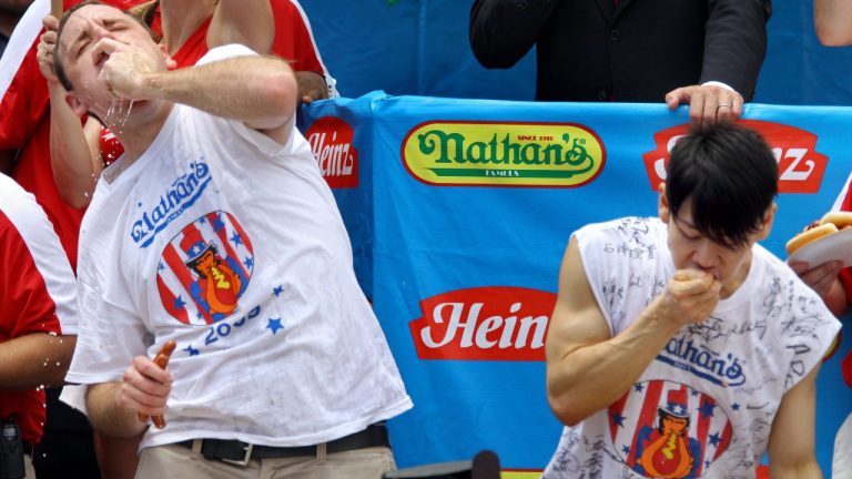 Joey Chestnut, left, of San Jose, Calif., defending champion of the Nathan's Famous July 4th Hot Dog Eating Contest works to outpace former champion Takeru Kobayashi, of Nagano, Japan, right, as Chestnut was on his way to his third consecutive win in Coney Island's annual hot dog eating contest with a world-record 68 franks in New York Saturday, July 4, 2009. (Craig Ruttle/AP)