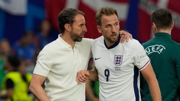 England's Harry Kane, listens to Gareth Southgate during a match between Denmark and England at the Euro 2024 tournament, June 20, 2024. (AP Photo/Thanassis Stavrakis)