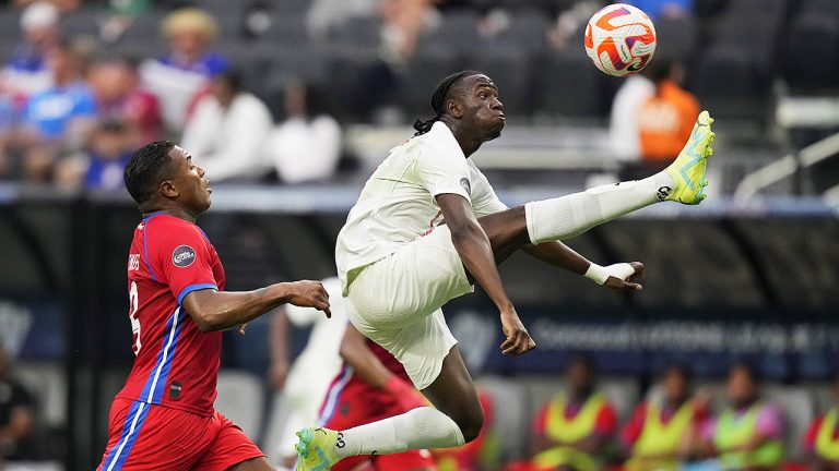 Canada's Ismael Kone knocks the ball out of the air beside Harold Cummings of Panama during the CONCACAF Nations League semifinals. (John Locher/AP)