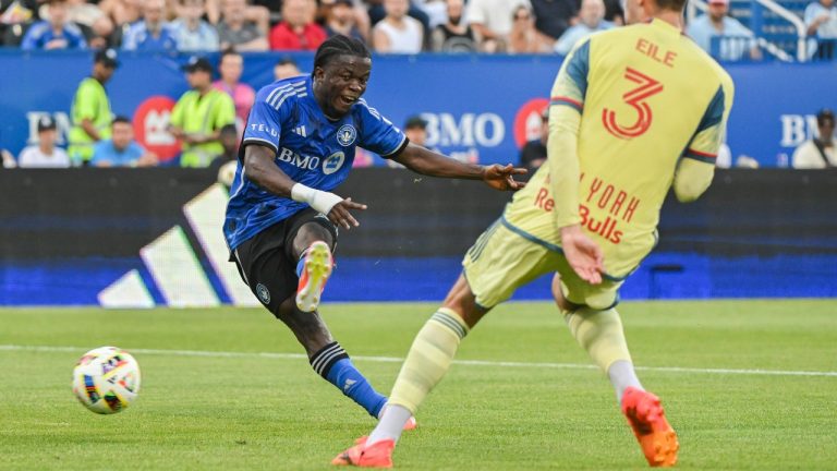 CF Montreal forward Kwadwo Opoku (7) scores against the New York Red Bulls as Red Bulls defender Noah Eile (3) looks on during first half MLS soccer action in Montreal. (Graham Hughes/CP)