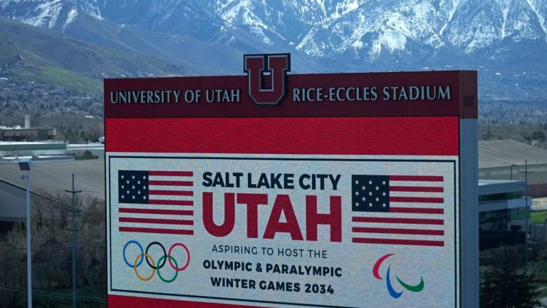 The scoreboard at the University of Utah's Rice-Eccles Stadium promotes bid to host Winter Olympics in 2034. (AP Photo/Rick Bowmer)