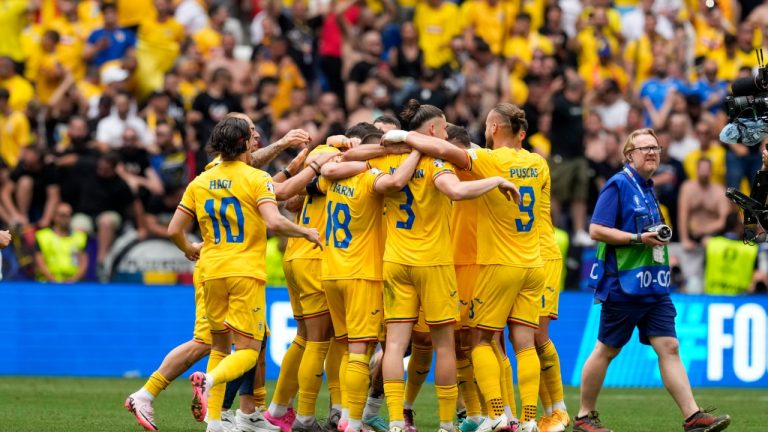Players of Romania celebrate at the end of a match against Ukraine at the Euro 2024 tournament, June 17, 2024. (AP Photo/Antonio Calanni)