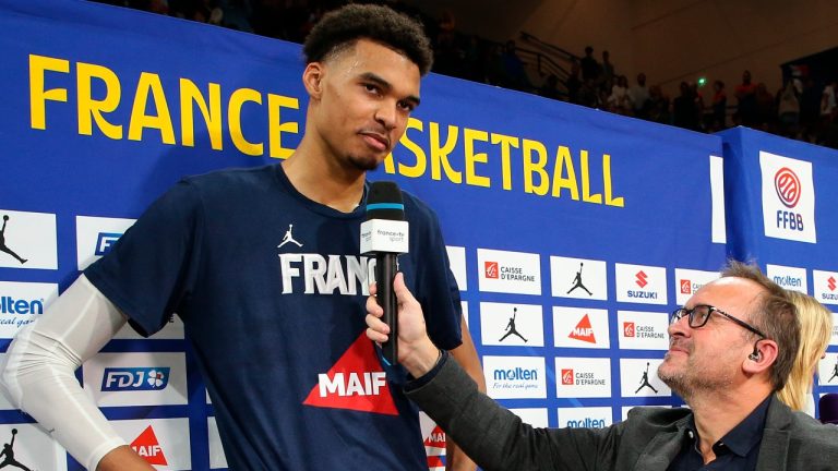 France's Victor Wembanyama speaks with a journalist after the FIBA World Cup Qualifiers match between France and Bosnia, Nov. 14, 2022. (AP Photo/Bob Edme, File)