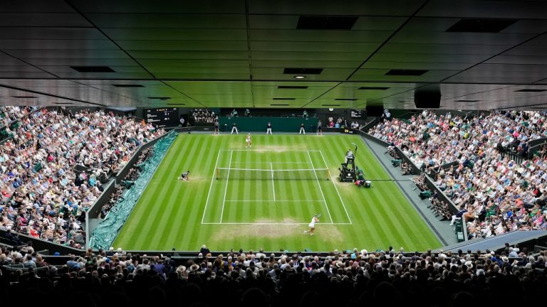 Elina Svitolina, top, plays Marketa Vondrousova in a women's singles semifinal match at Wimbledon, Thursday, July 13, 2023. (AP Photo/Kirsty Wigglesworth)