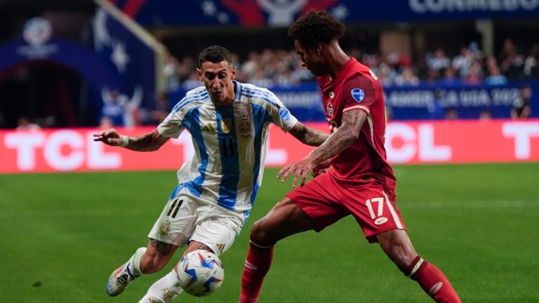 Argentina's Angel Di Maria, left, and Canada's Tajon Buchanan battle for the ball during a Copa America Group A soccer match in Atlanta, Thursday, June 20, 2024. (Mike Stewart/AP Photo)