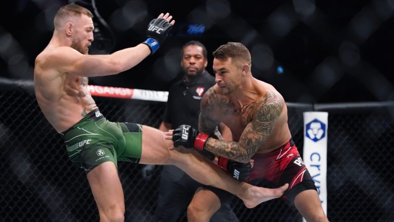 Conor McGregor, left, kicks Dustin Poirier during their UFC 264 lightweight mixed martial arts bout in Las Vegas in 2021. (John Locher/AP)