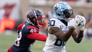 Toronto Argonauts wide receiver DaVaris Daniels (80) makes the catch past Montreal Alouettes defensive back Kabion Ento (48) during first half CFL football action in Montrea. (Christinne Muschi/THE CANADIAN PRESS)