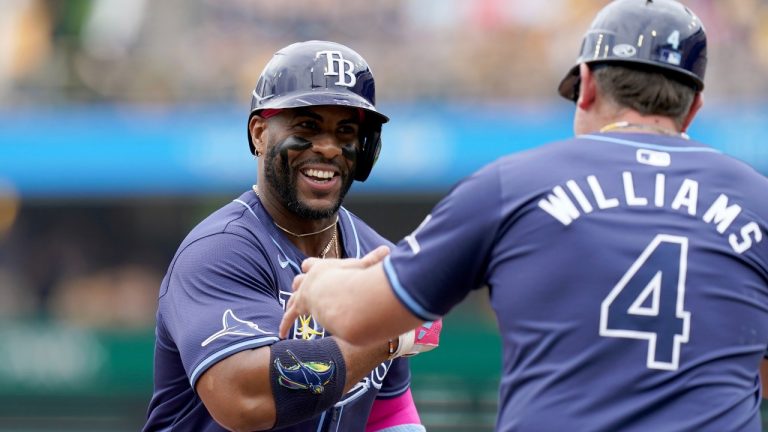 Tampa Bay Rays' Yandy Diaz, left, is greeted by third base coach Brady Williams, right, as he rounds the bases after hitting a home run during the first inning of a baseball game against the Pittsburgh Pirates, Sunday, June 23, 2024, in Pittsburgh. (Matt Freed/AP)