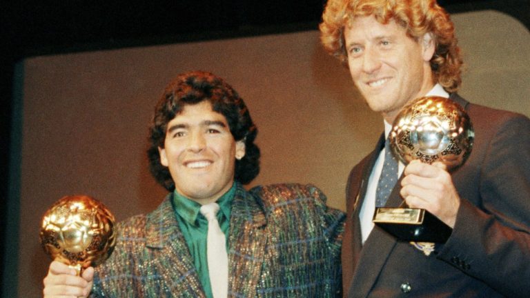 Argentina's soccer star Diego Maradona, left, and West German goalkeeper Harald Schumacher are holding their World Cup Soccer Ball awards while posing with two young soccer players during the Soccer Golden Shoe Award ceremony held in Paris, France, on Nov. 13, 1986. Diego Maradona's heirs filed a lawsuit to try to stop the auction of a trophy he was awarded after the 1986 World Cup won by Argentina. (Michael Lipchitz/AP Photo, File)