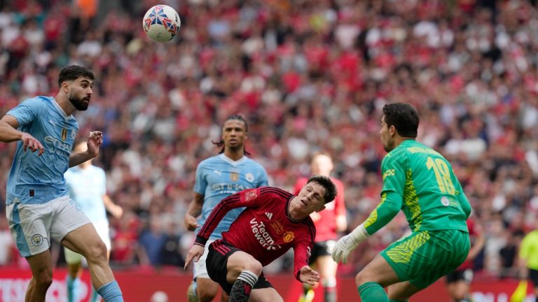 Manchester City's Josko Gvardiol, left, heads the ball to his goalkeeper Manchester City's goalkeeper Stefan Ortega, right, before Manchester United's Alejandro Garnacho, center, scores his side's opening goal during the English FA Cup final soccer match between Manchester City and Manchester United at Wembley Stadium in London, Saturday, May 25, 2024. (Kin Cheung/AP)
