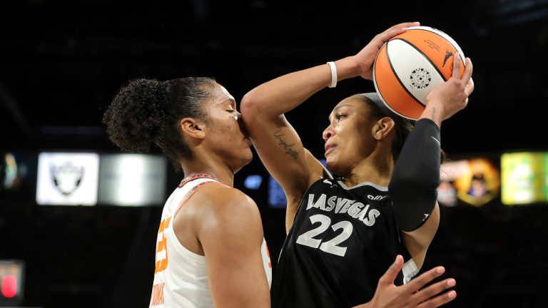 Connecticut Sun forward Alyssa Thomas (25) defends against Las Vegas Aces center A'ja Wilson (22) during the second half of a WNBA basketball game Friday, June 21, 2024, in Las Vegas. (Steve Marcus/Las Vegas Sun via AP)