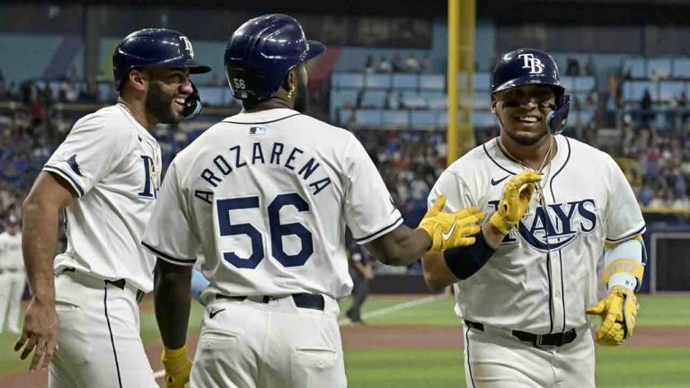 Tampa Bay Rays' Isaac Paredes, right, celebrates with Amed Rosario, left, and Randy Arozarena (56) after hitting a three-run home run off New York Yankees starter Carlos Rodón in the first inning of a baseball game Tuesday, July 9, 2024, in St. Petersburg, Fla. (Steve Nesius/AP)
