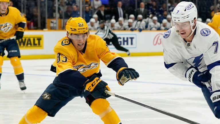 Tampa Bay Lightning's Haydn Fleury, right, moves the puck against Nashville Predators defenceman Adam Wilsby, left, during an NHL preseason game, Sept. 30, 2022. (AP Photo/Mark Humphrey)