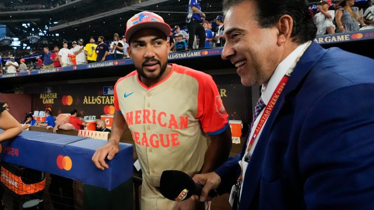 American League's Anthony Santander, center, of the Baltimore Orioles, stands near the dugout before the MLB All-Star baseball game, Tuesday, July 16, 2024, in Arlington, Texas. (LM Otero/AP)