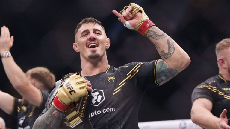 Tom Aspinall celebrates as he becomes heavyweight champion after beating Curtis Blaydes during the Heavyweight bout at the Co-op Live Arena, Manchester, England, Sunday July 28, 2024. (Richard Sellers/PA via AP)
