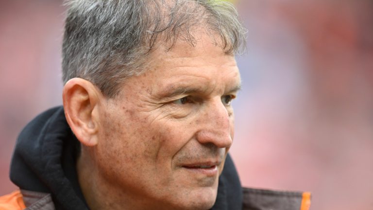 Former Cleveland Browns quarterback Bernie Kosar stands on the field before an NFL football game between the Tampa Bay Buccaneers and the Cleveland Browns, Sunday, Nov. 27, 2022, in Cleveland. The former Browns great is in “the fight of his life” dealing with liver failure and the early stages of Parkinson’s disease, Cleveland Magazine reports. (David Richard/AP)