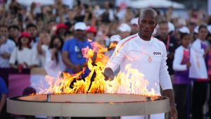 Torchbearer Didier Drogba holds the Olympic torch to light the cauldron at the Velodrome stadium in Marseille, southern France, Thursday, May 9, 2024. (Daniel Cole/AP)