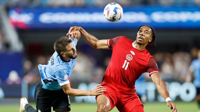 Uruguay's Rodrigo Bentancur, left, and Canada's Theo Bair fight for the ball during the Copa America third place soccer match in Charlotte, N.C., Saturday, July 13, 2024. (Nell Redmond/AP) 