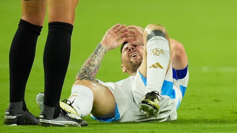 Argentina's Lionel Messi grimaces in pain during the Copa America final soccer match against Colombia in Miami Gardens, Fla., Sunday, July 14, 2024. (Rebecca Blackwell/AP)
