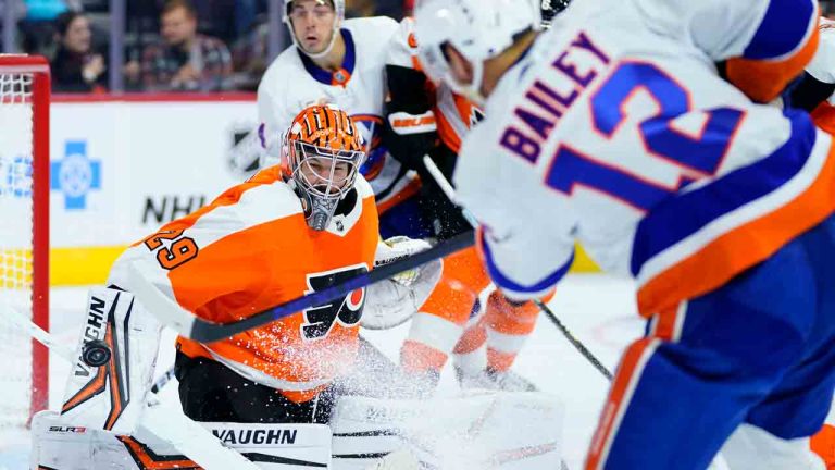 Philadelphia Flyers' Troy Grosenick, left, blocks a shot by New York Islanders' Josh Bailey during the third period of a pre-season NHL hockey game, Tuesday, Oct. 4, 2022, in Philadelphia. (Matt Slocum/AP)