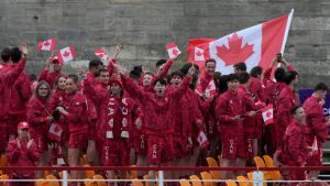 Canadian athletes wave from a boat on the Seine River during the opening ceremony for the 2024 Summer Olympics in Paris on Friday, July 26, 2024. (Adrian Wyld/CP Photo)