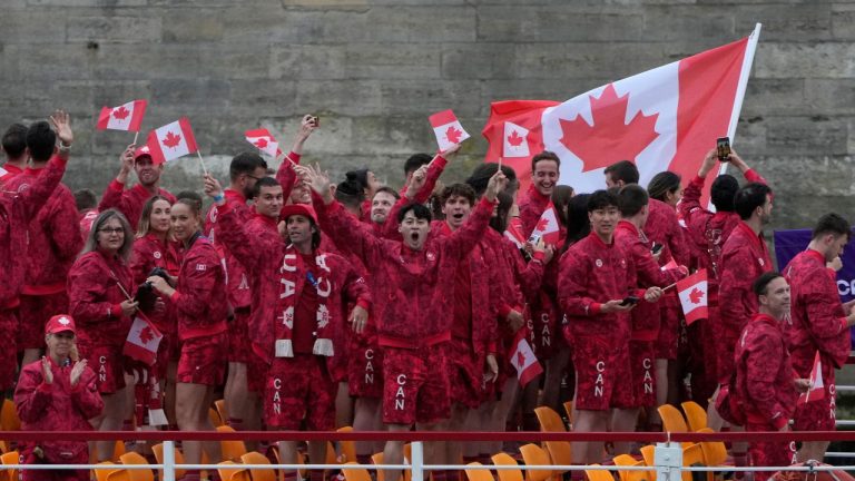 Canadian athletes wave from a boat on the Seine River during the opening ceremony for the 2024 Summer Olympics in Paris on Friday, July 26, 2024. (Adrian Wyld/CP Photo)