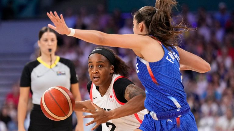 Shay Colley, of Canada, drives into Marine Fauthoux, of France, in a women's basketball game at the 2024 Summer Olympics, Monday, July 29, 2024, in Villeneuve-d'Ascq, France. (Mark J. Terrill/AP Photo)