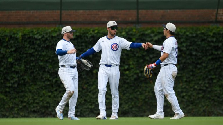 Chicago Cubs outfielders Ian Happ, left, Cody Bellinger, center, and Seika Suzuki, right, celebrate after defeating the Philadelphia Phillies. (Paul Beaty/AP)