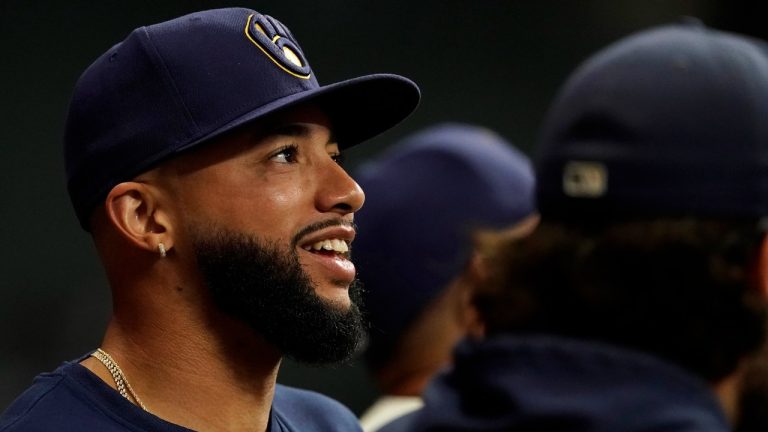 Milwaukee Brewers' Devin Williams smiles in the dugout during the ninth inning of a baseball game against the Pittsburgh Pirates Wednesday, July 10, 2024, in Milwaukee. (AP Photo/Aaron Gash)