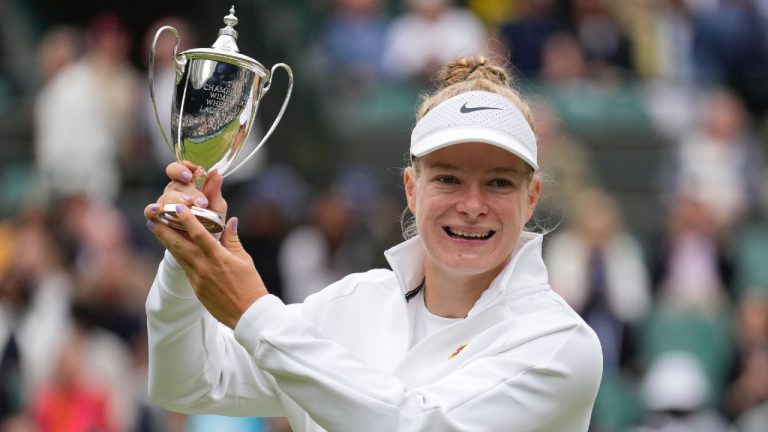 Diede De Groot of the Netherlands holds her trophy aloft after defeating compatriot Aniek Van Koot in the women's wheelchair final at the Wimbledon tennis championships in London, Saturday, July 13, 2024. (Mosa'ab Elshamy/AP)