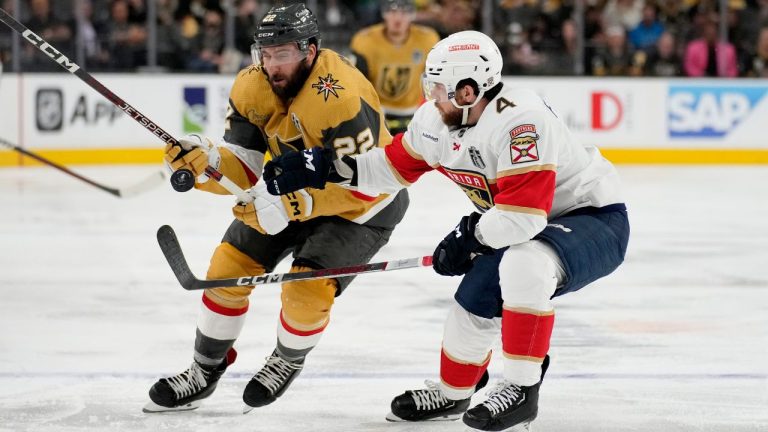 Vegas Golden Knights right wing Michael Amadio (22) and Florida Panthers defenceman Casey Fitzgerald (4) battle for the puck during the second period of Game 2 of the NHL hockey Stanley Cup Finals, Monday, June 5, 2023, in Las Vegas. (John Locher/AP Photo)