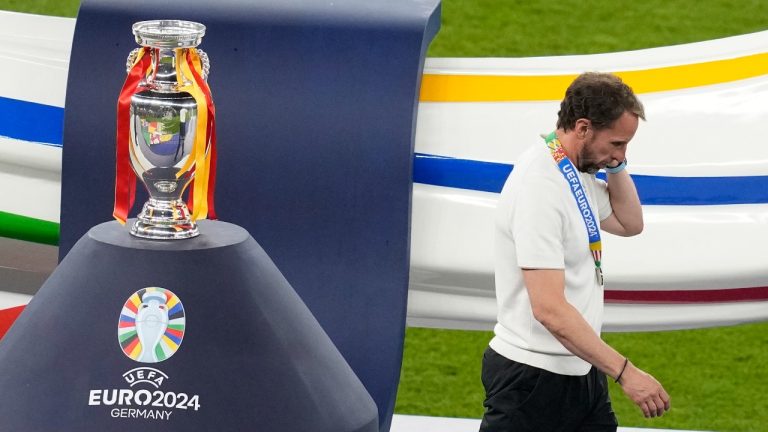 England's manager Gareth Southgate passes walk next to the trophy at the end of the final match against Spain at the Euro 2024 tournament in Berlin, Germany, July 14, 2024. (AP Photo/Thanassis Stavrakis)