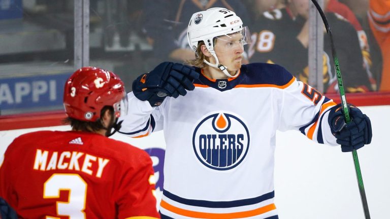 Edmonton Oilers' James Hamblin celebrates his goal as Calgary Flames' Connor Mackey looks on during second period preseason NHL hockey action in Calgary, Alta., Sunday, Sept. 26, 2021. (Jeff McIntosh/CP Photo)