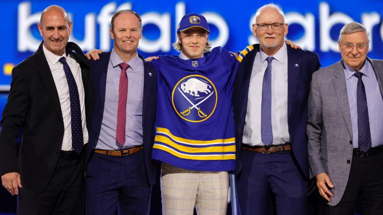 Konsta Helenius, centre, poses after being selected by the Buffalo Sabres during the first round of the NHL hockey draft Friday, June 28, 2024, in Las Vegas. (Steve Marcus/AP)