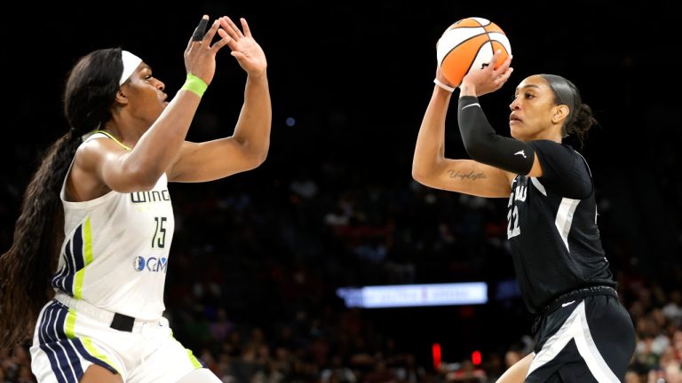 Las Vegas Aces center A'ja Wilson (22) looks to shoot over Dallas Wings center Teaira McCowan (15) during the second half of a WNBA basketball game Sunday, July 7, 2024, in Las Vegas. (Steve Marcus/Las Vegas Sun via AP)