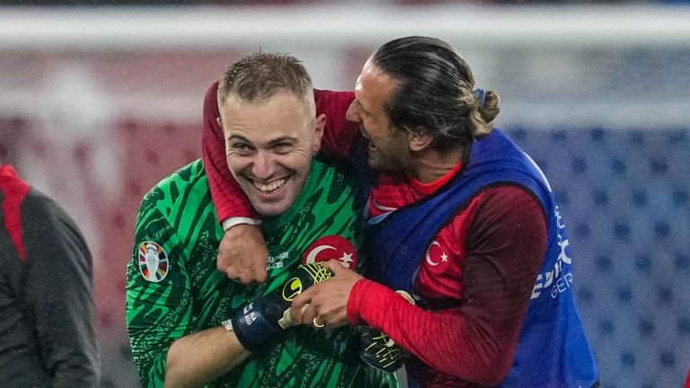 Turkey's goalkeeper Mert Gunok gets a hug after a  match between Austria and Turkey at the Euro 2024 tournament in Leipzig, Germany, July 2, 2024. (AP Photo/Andreea Alexandru)